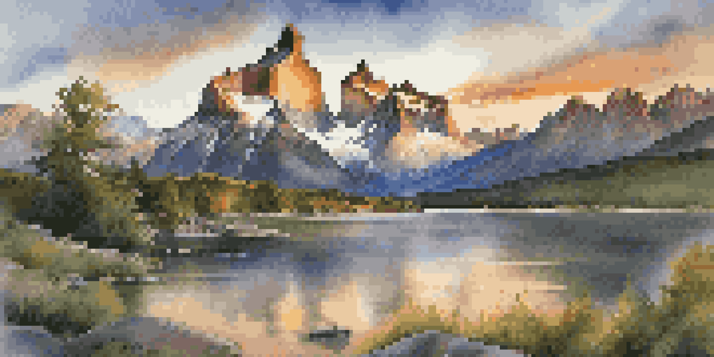 A stunning sunset view of the granite Towers of Paine, reflecting in a glacial lake with vibrant colors in the sky and lush greenery in the foreground.