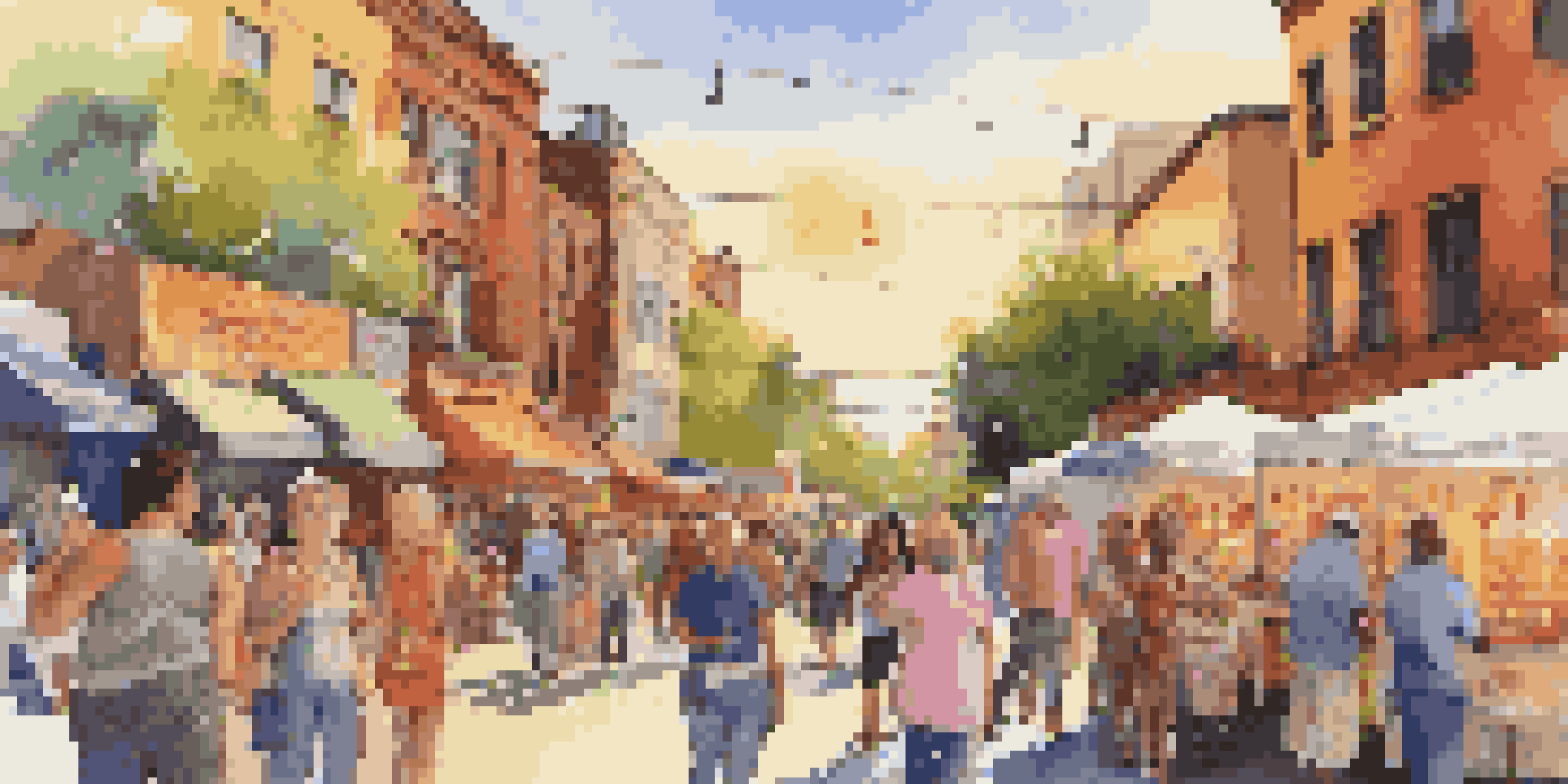 A lively street scene during an art walk with local artists displaying their works, people conversing, and food vendors in the background.