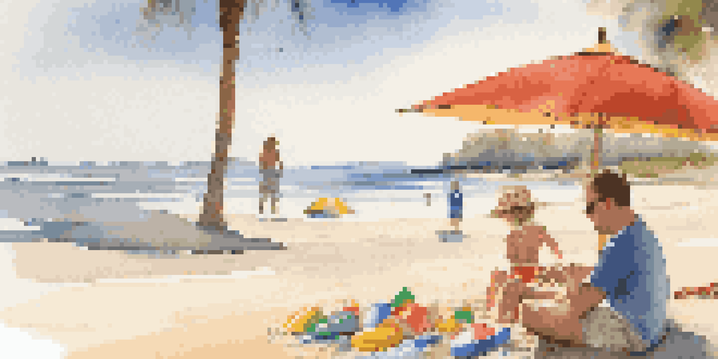 A young child playing with beach toys on a sandy beach while parents relax nearby under an umbrella.