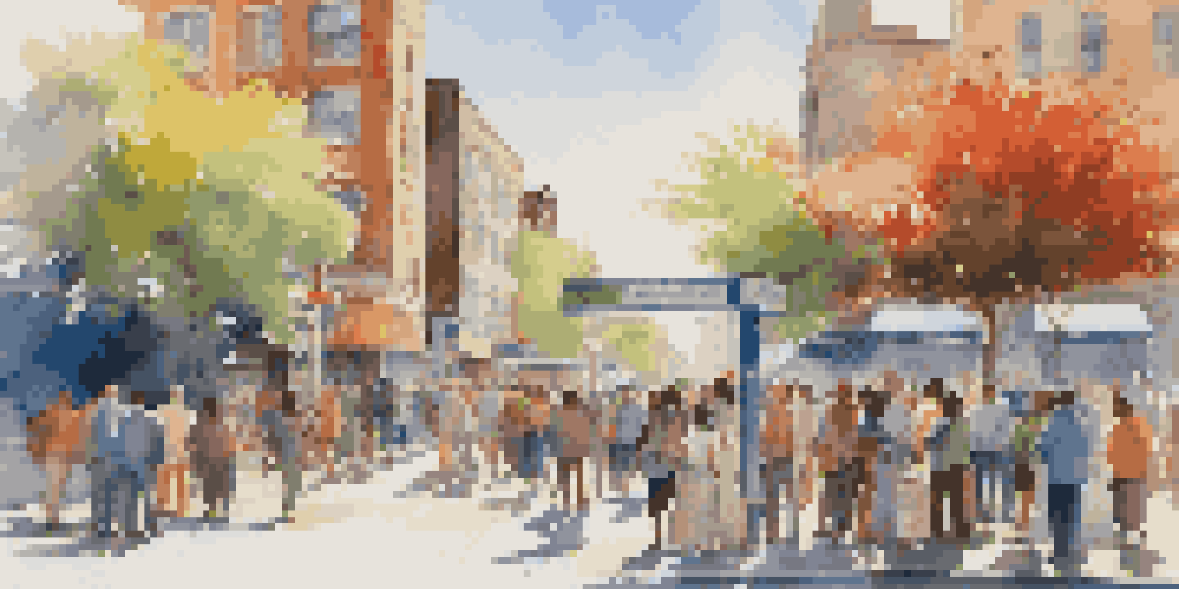 A busy city street with people at a bus stop, colorful buildings, and bright flowers in planters under a blue sky.