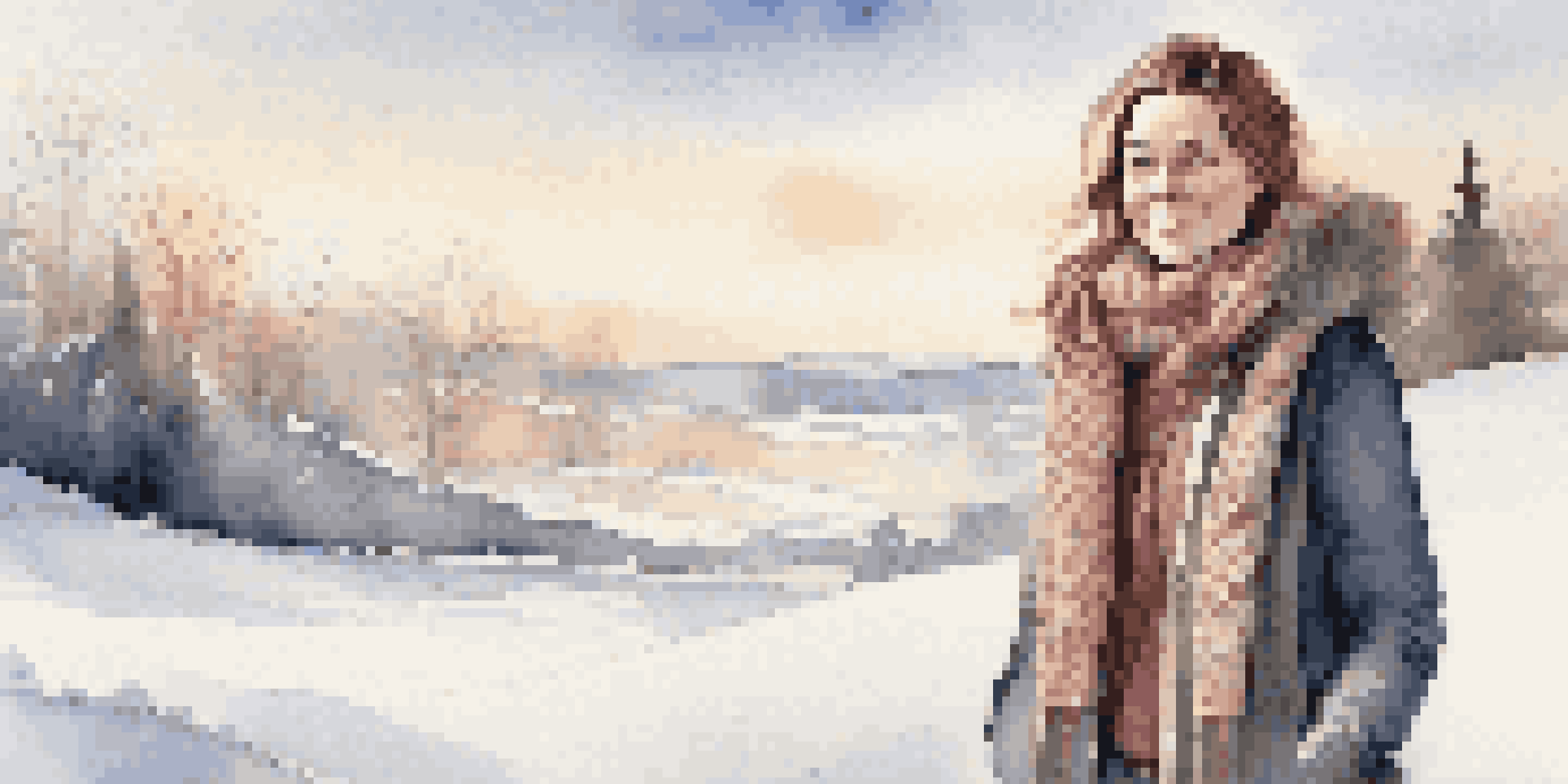 A woman dressed in layers of winter clothing, including a sweater and a coat, standing in a snowy landscape under soft sunlight.