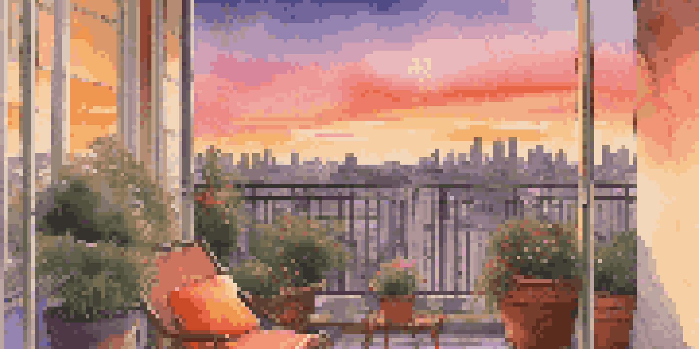 A beautiful sunset from a hotel balcony with colorful skies and a city skyline in the background.