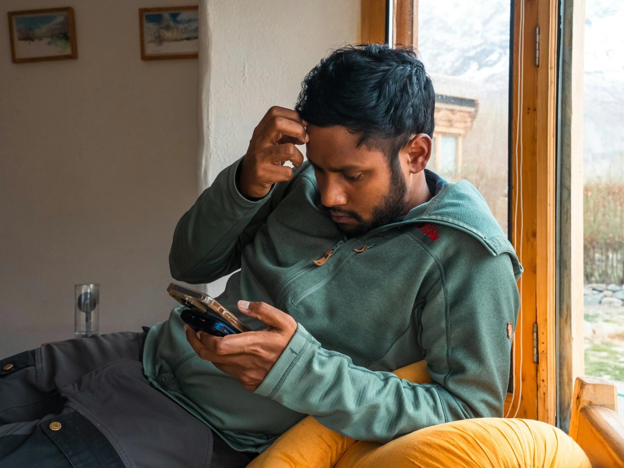 A man frowning at his phone, unsure about a message he has received.