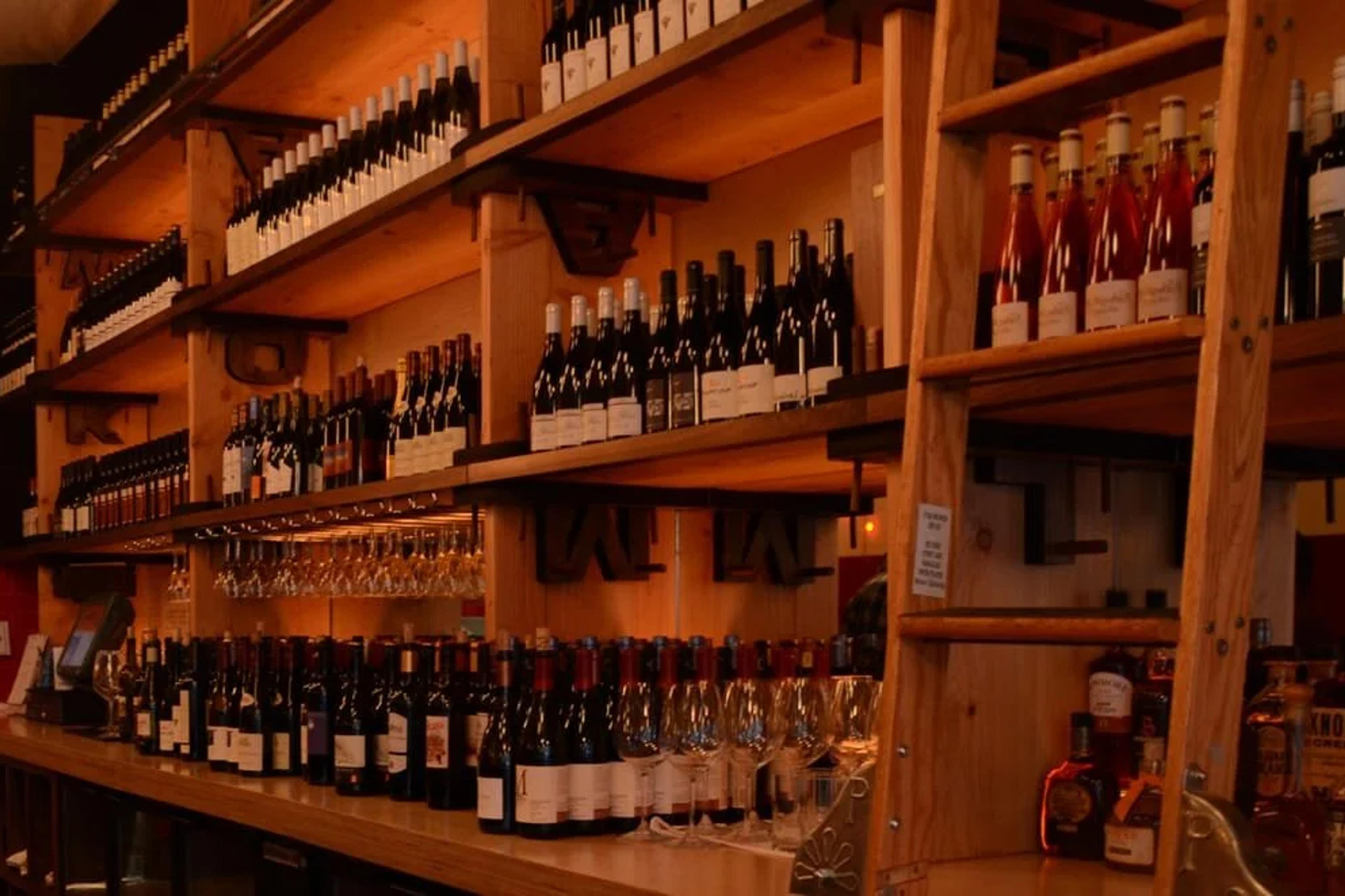Wine bottles on the shelves behind the bar at Amélie West Village