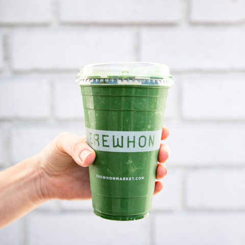 Hand holding green juice