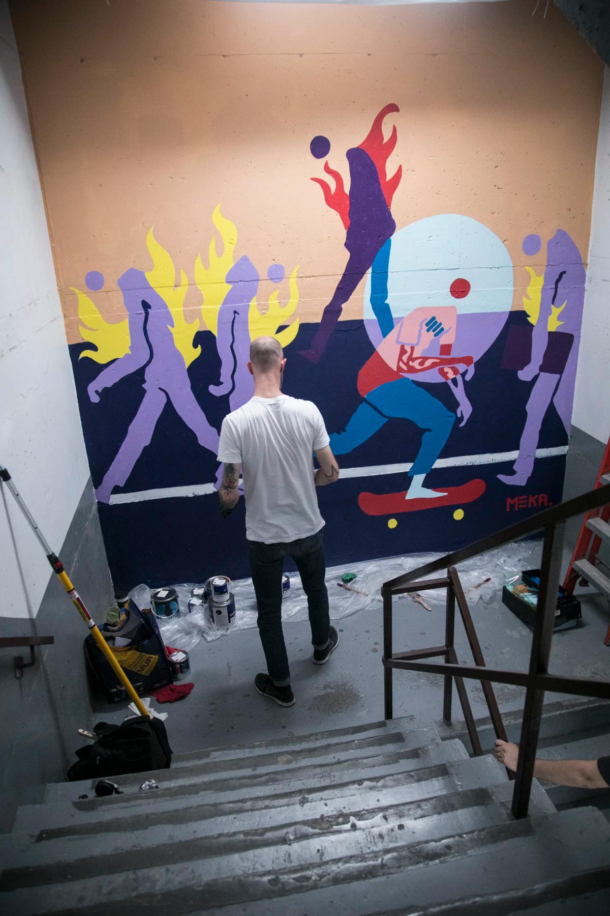 The finished Keep Pushing mural in the Romeo's Museum stairwell