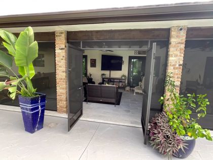 Pool-side patio screen room with outdoor furniture in South Florida