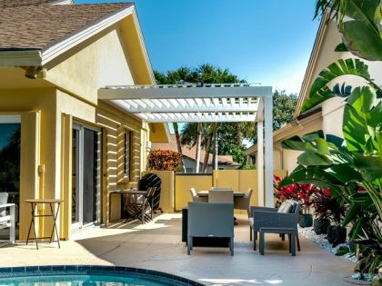 Motorized louvered roof with open slats over a Miami-Dade patio
