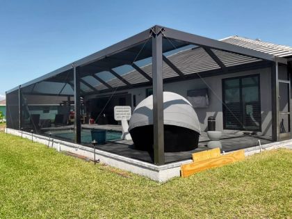 Interior of a pool screen enclosure with patio furniture in South Florida