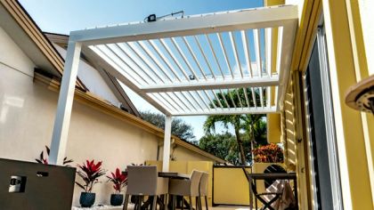 Motorized louvered roof over a patio in Wellington, Palm Beach County — rain protection in South Florida