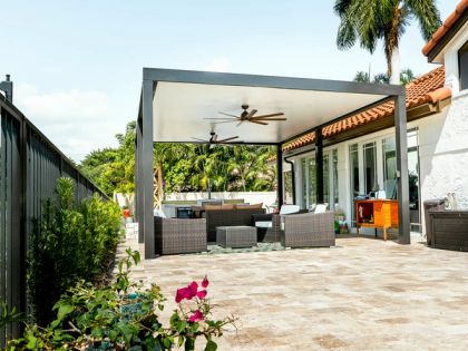 White aluminum pergola with open lattice roof, backyard installation at South Florida home with tropical plants and patio area — AB Aluminum & Screens