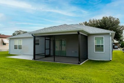 Attached aluminum screen room enclosing a back patio in South Florida