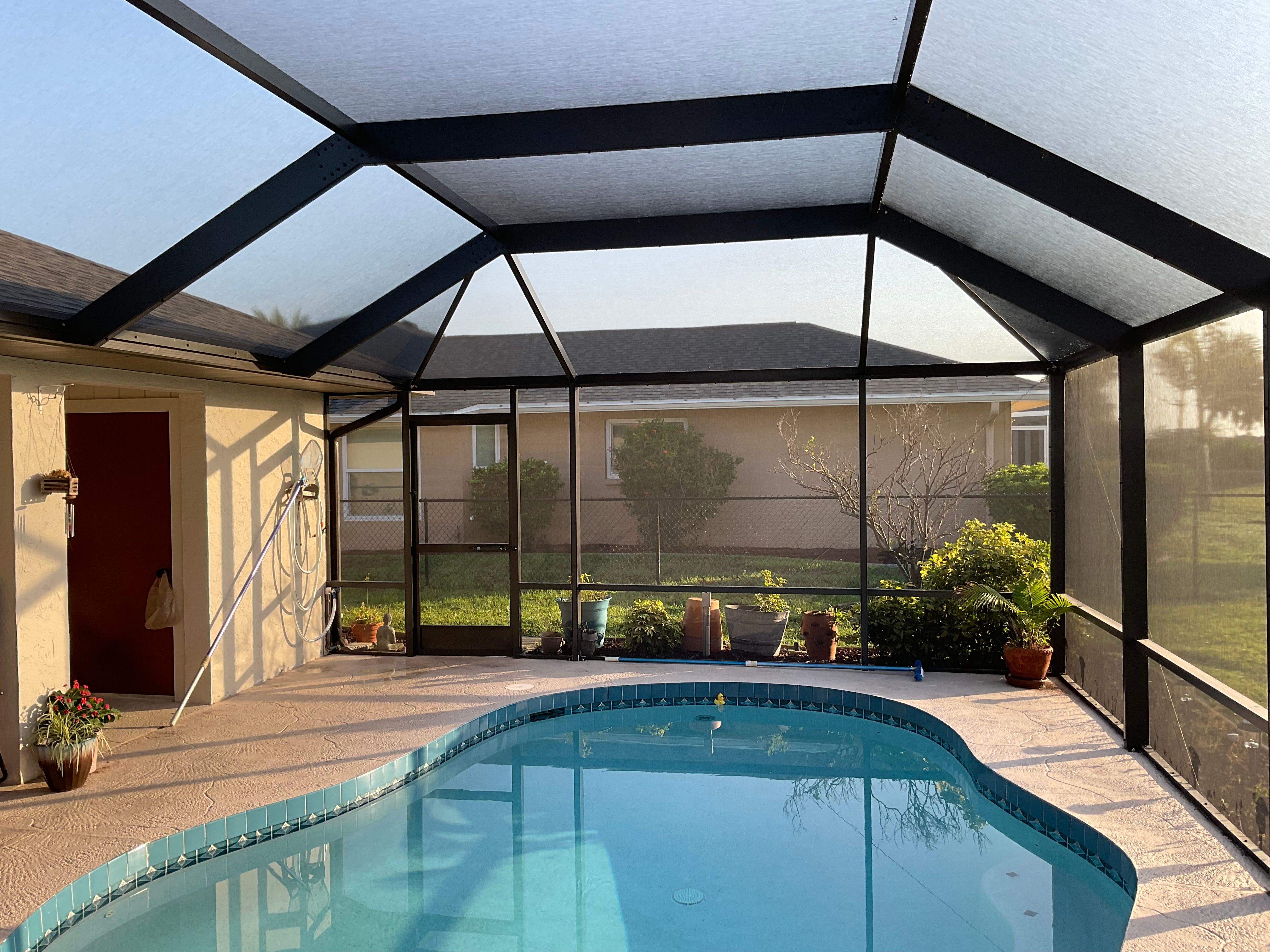 Pool cage installation suburban home backyard Miami-Dade — AB Aluminum & Screens