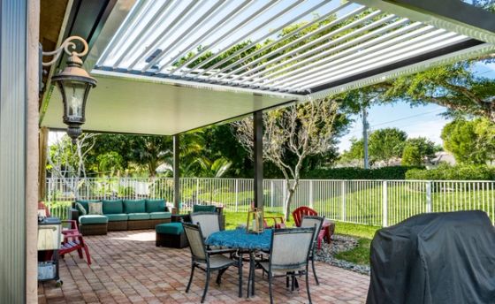 White aluminum open-lattice pergola at South Florida residential home, patio cover with tropical garden and palm trees — AB Aluminum & Screens