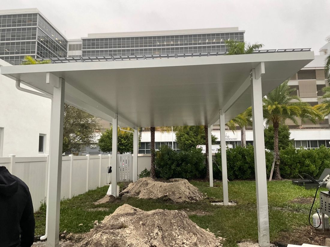 Aluminum pergola over a backyard patio in Southwest Ranches, Broward County — patio cover vs. pergola