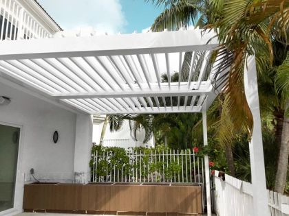 Louvered roof with closed slats over a pool patio in South Florida