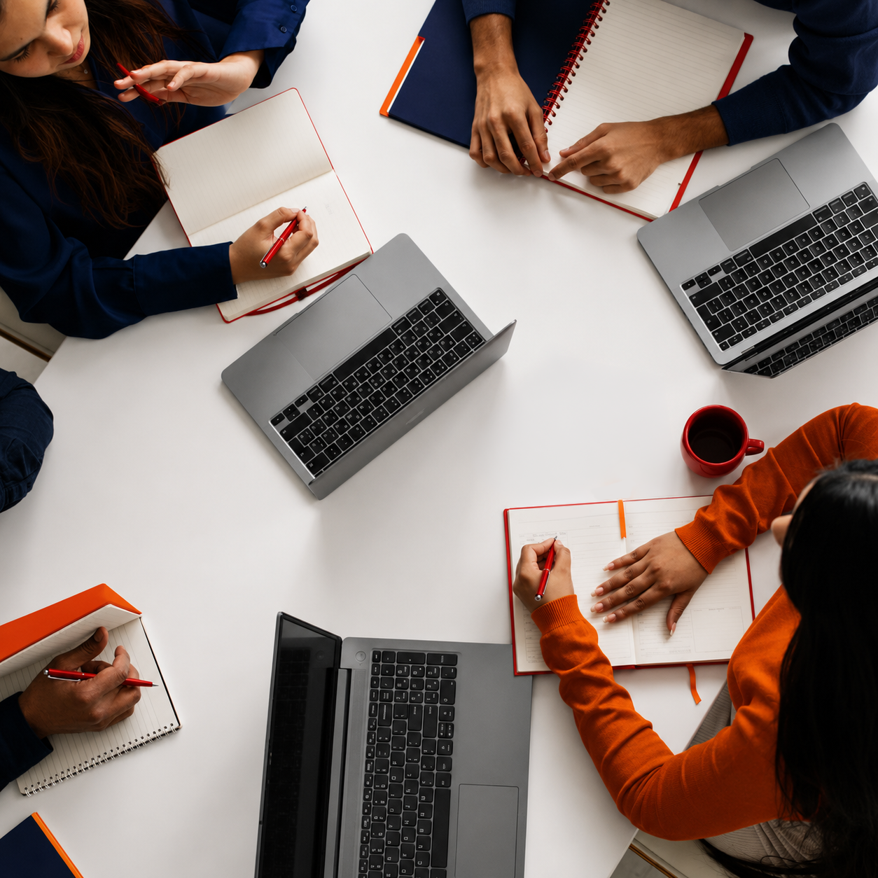 aerial view of people on their laptops working together