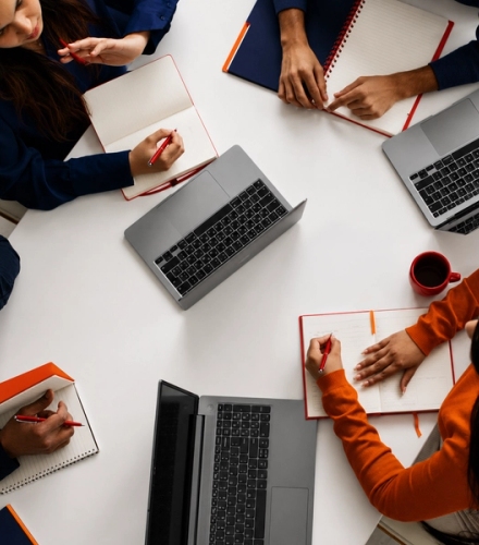 aerial view of people on their laptops working together