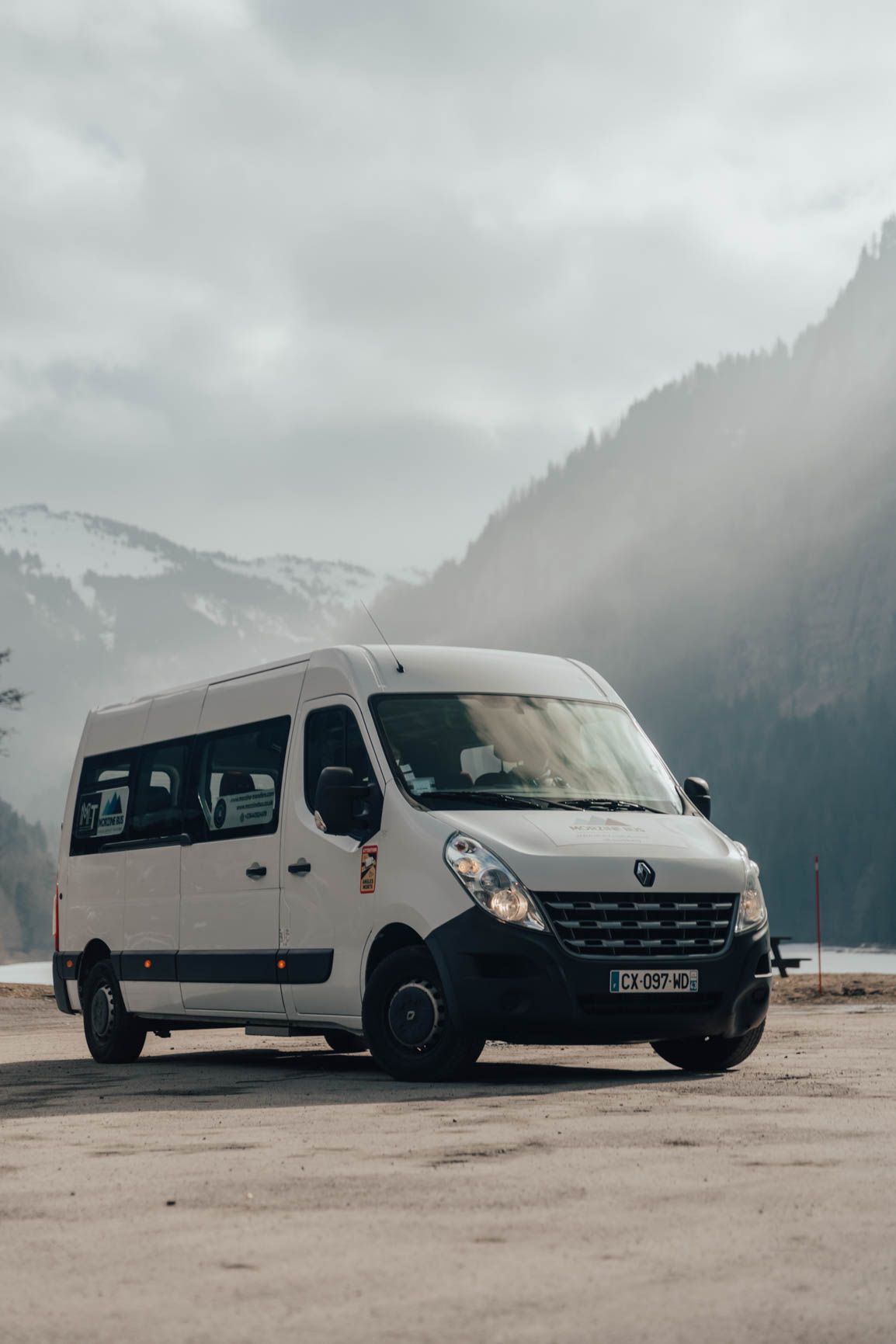 White Renault Master 13-seat minibus in a snowy valley