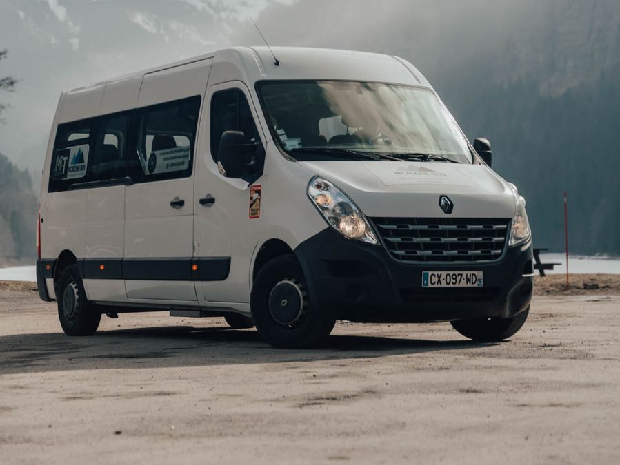 White Renault Master 13-seat minibus in a snowy valley