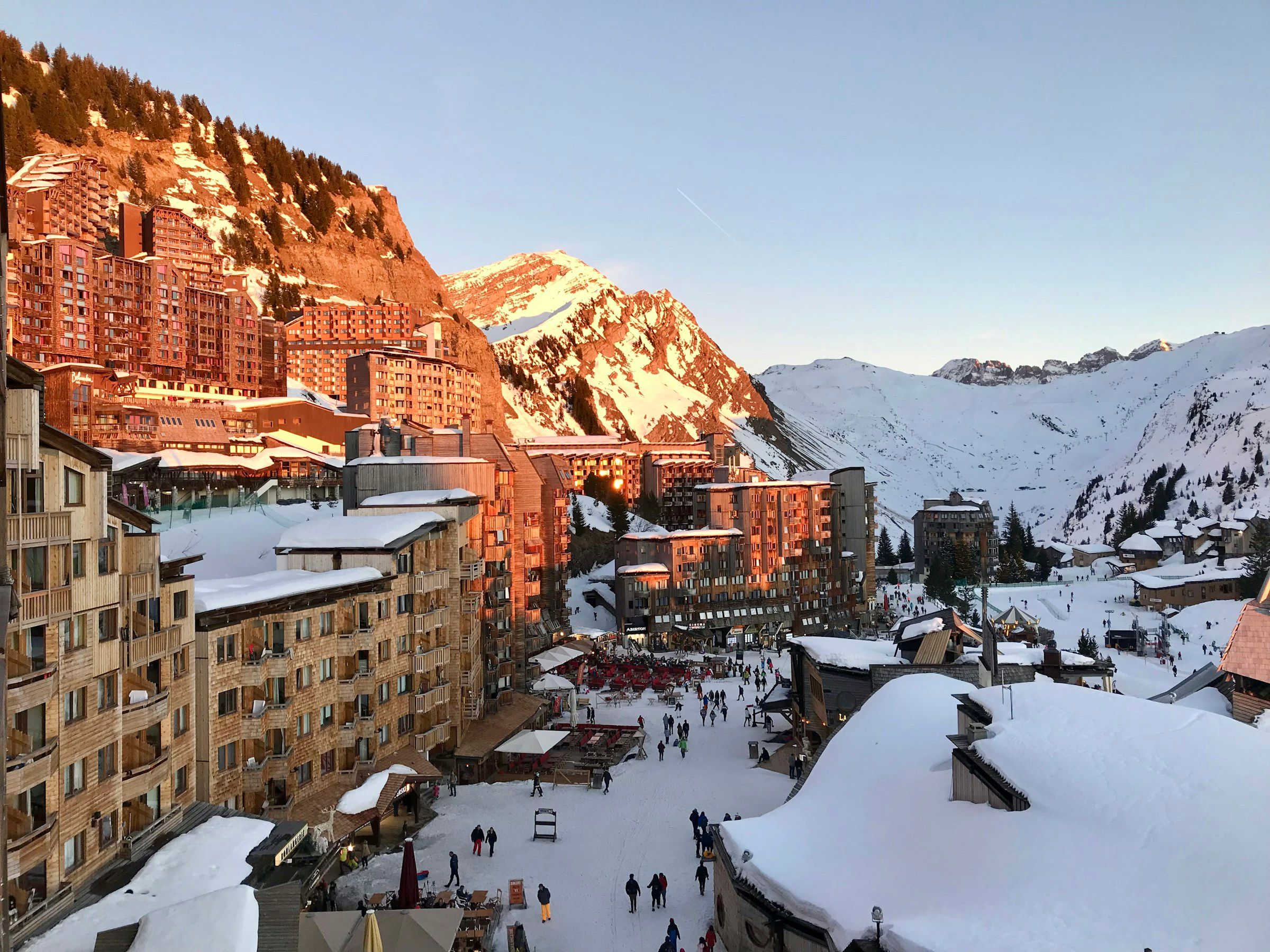 Avoriaz's wood-clad buildings glowing at sunset above the snowy village