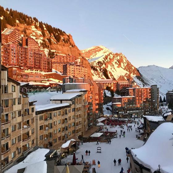 Avoriaz's wood-clad buildings glowing at sunset above the snowy village