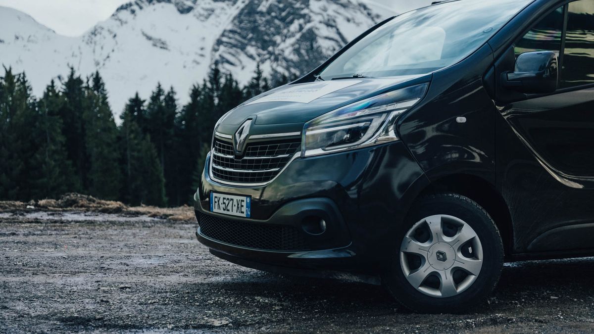 Morzine Bus Renault Trafic minibus parked in front of snowy Alpine peaks