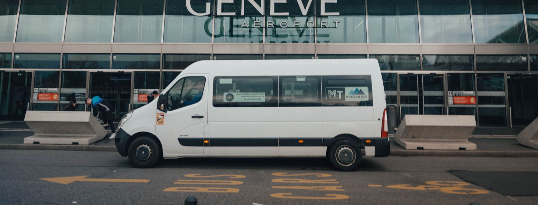 Morzine Bus minibus outside the Geneva Airport terminal