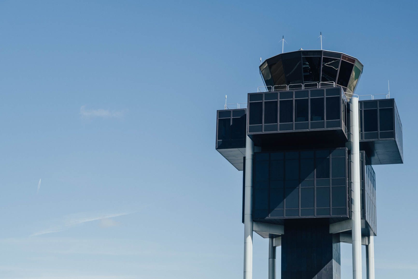 The Geneva Airport control tower against a blue sky