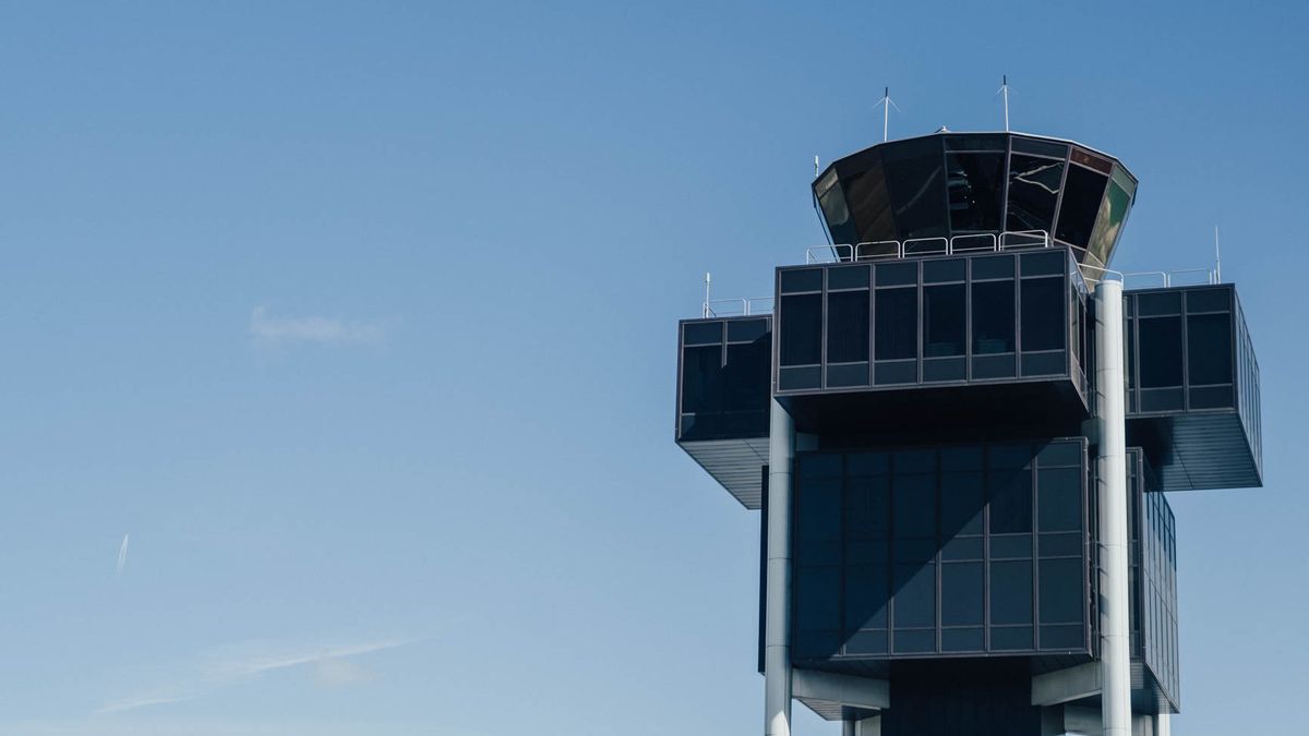 The Geneva Airport control tower against a blue sky