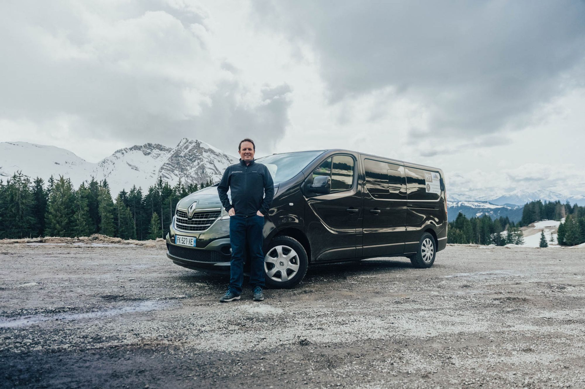 Morzine Bus driver standing beside his minibus in the mountains