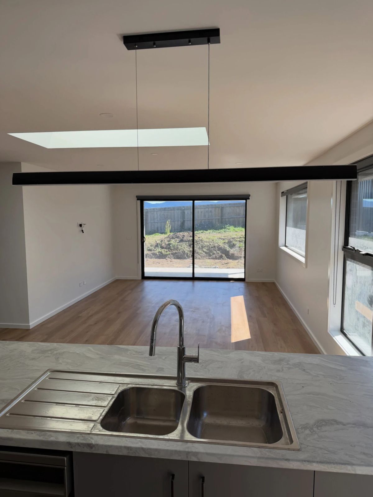 Kitchen looking through to a freshly painted living area