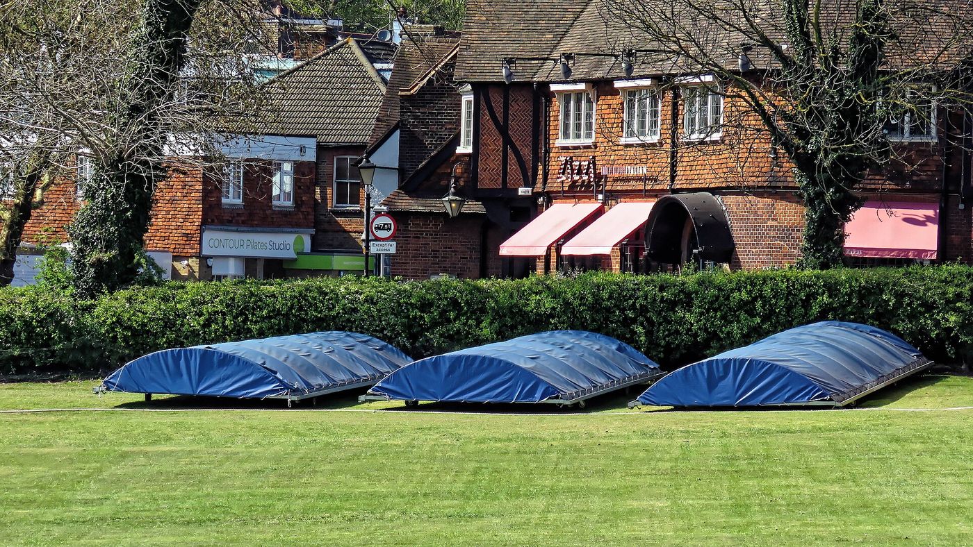 Mobile covers protecting a cricket pitch at a club ground in Kent
