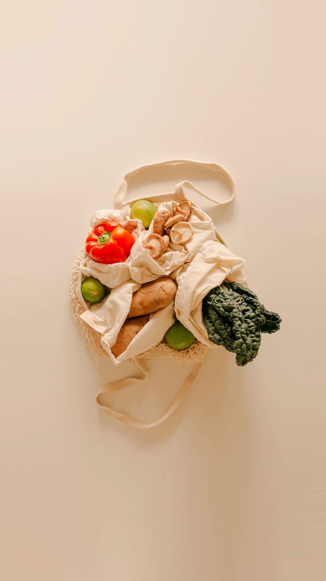 farmers market fresh fruits and vegetables in reusable organic cotton produce bags