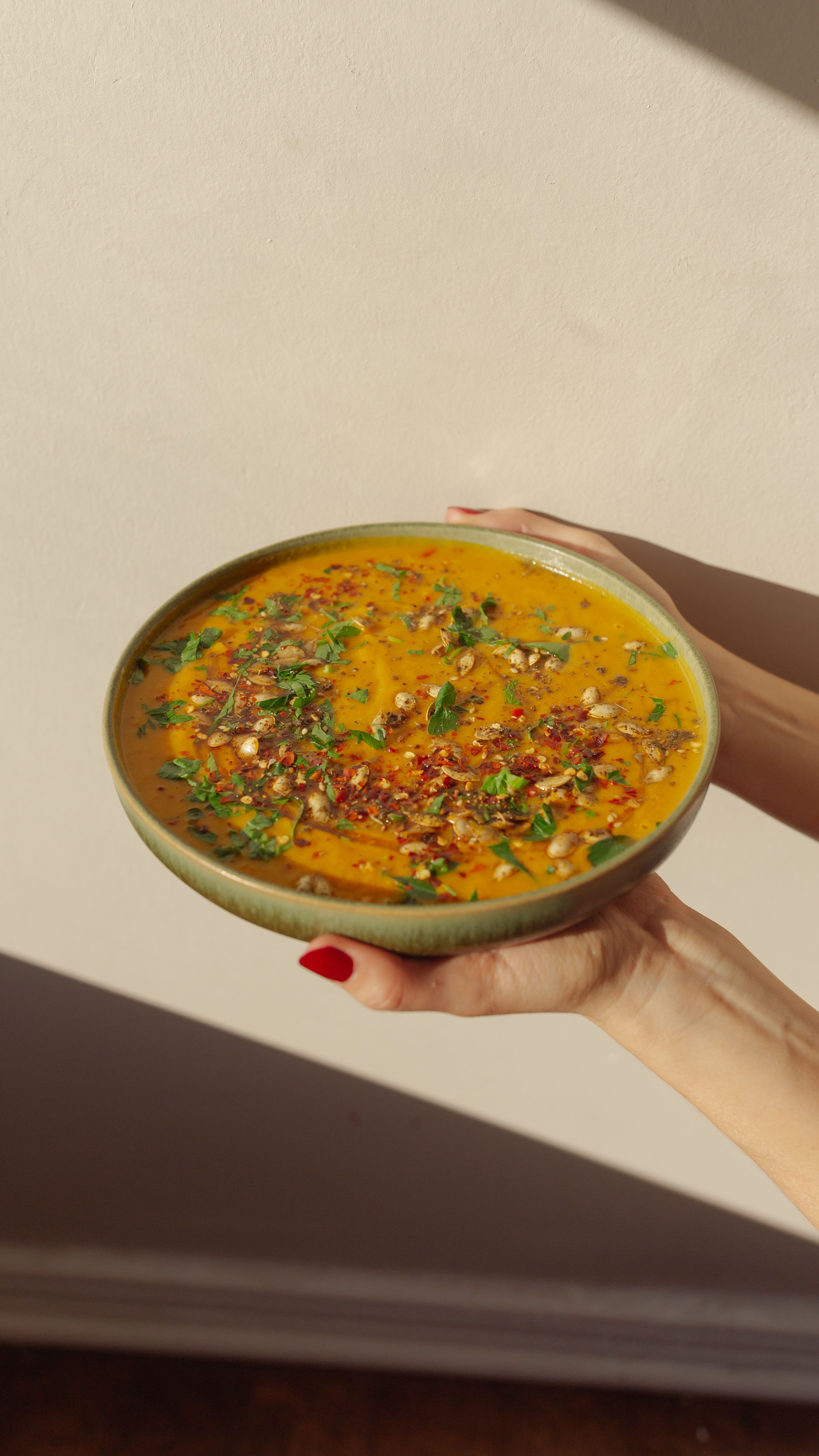 butternut squash soup in a bowl between shadows
