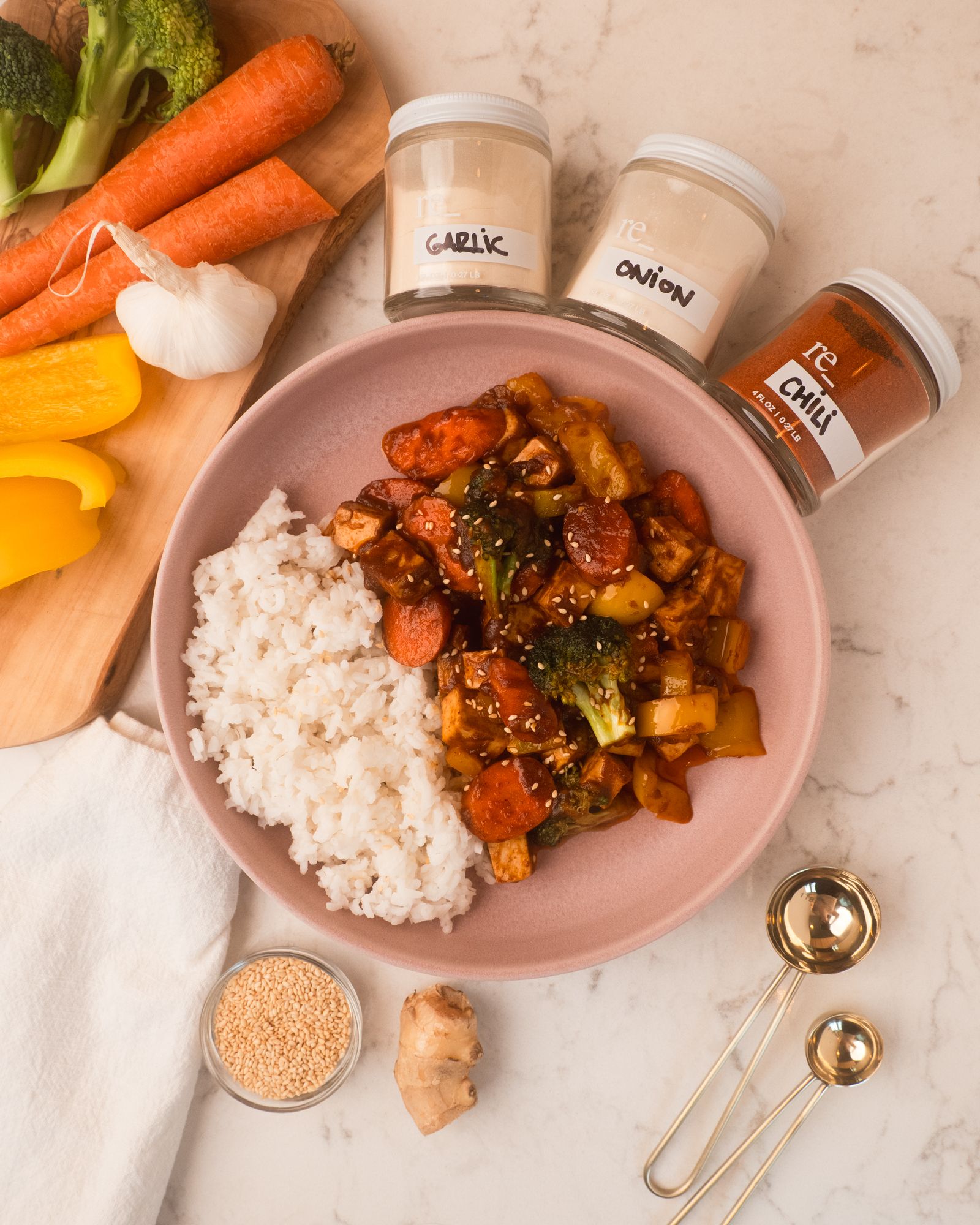 tofu vegetable stir fry with fresh veggies and re_ grocery spices on a marble countertop