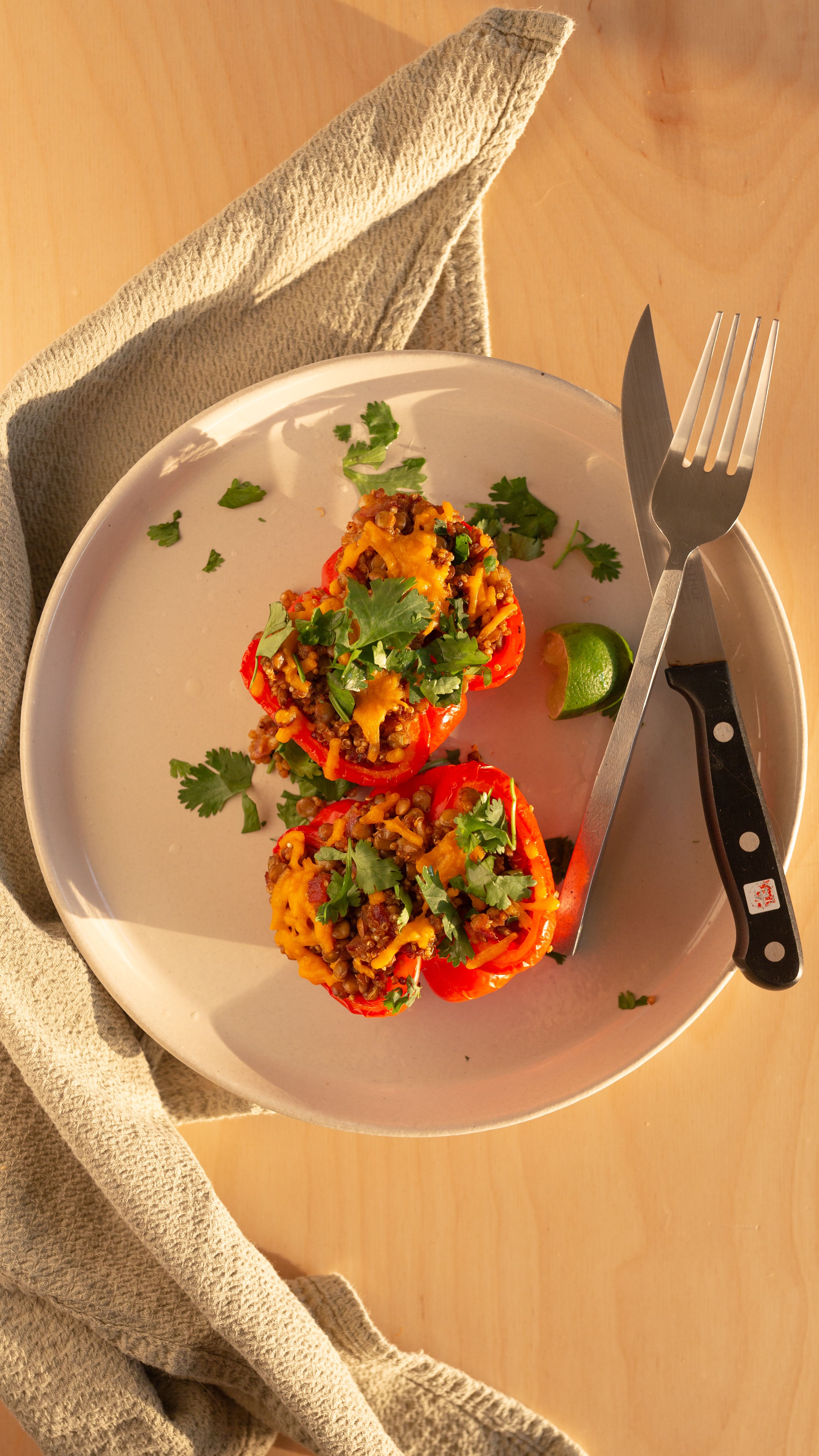 quinoa lentil stuffed bell peppers on a baltic birch table