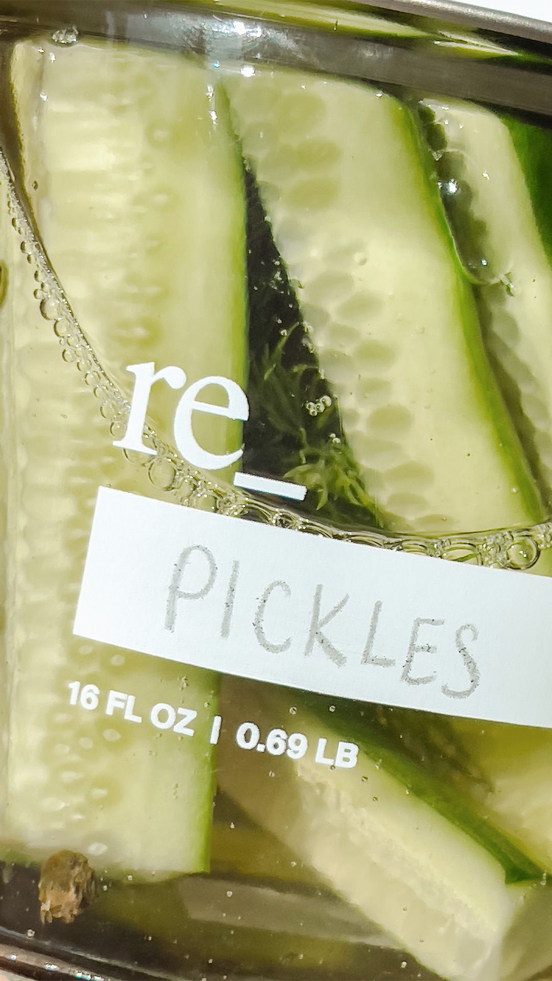 homemade pickels in 16oz glass re_ jar labeled in pencil