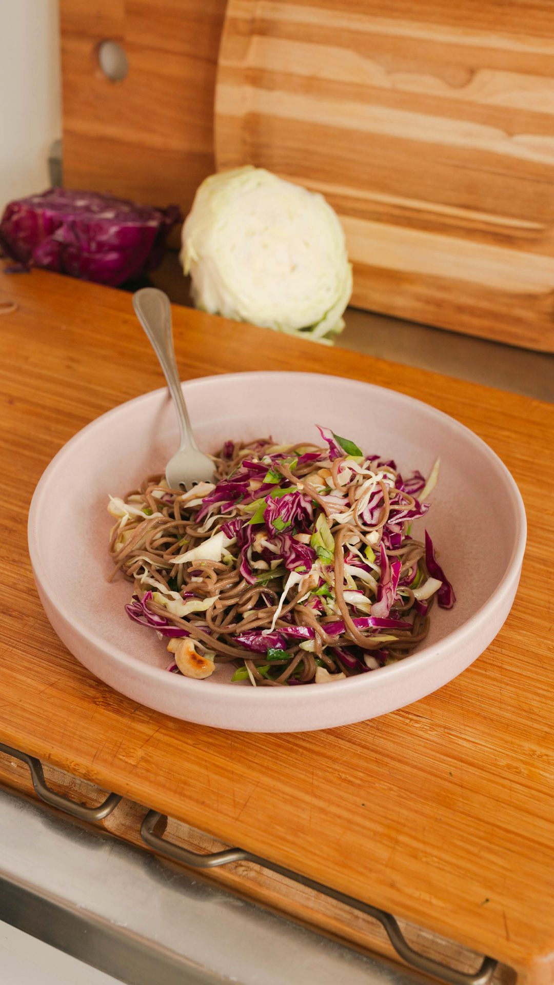 soba cabbage salad in a bowl on a wooden countertop