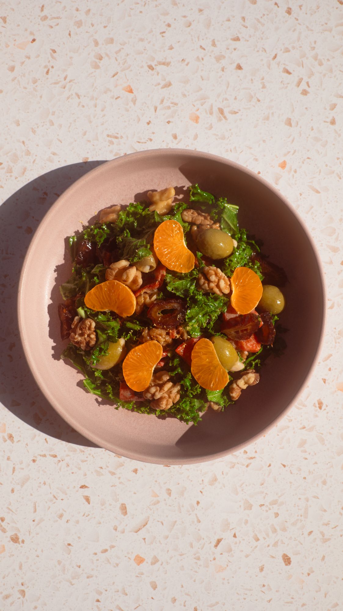 Honey Tahini Kale Salad on a terrazzo tile countertop