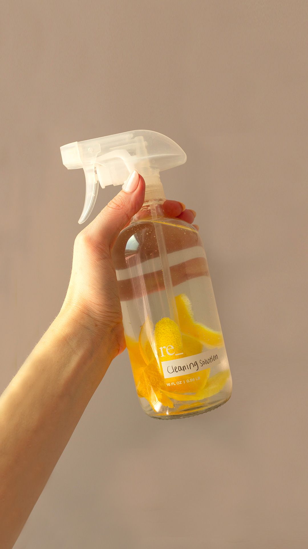 distilled white vinegar in a spray bottle with lemon peels