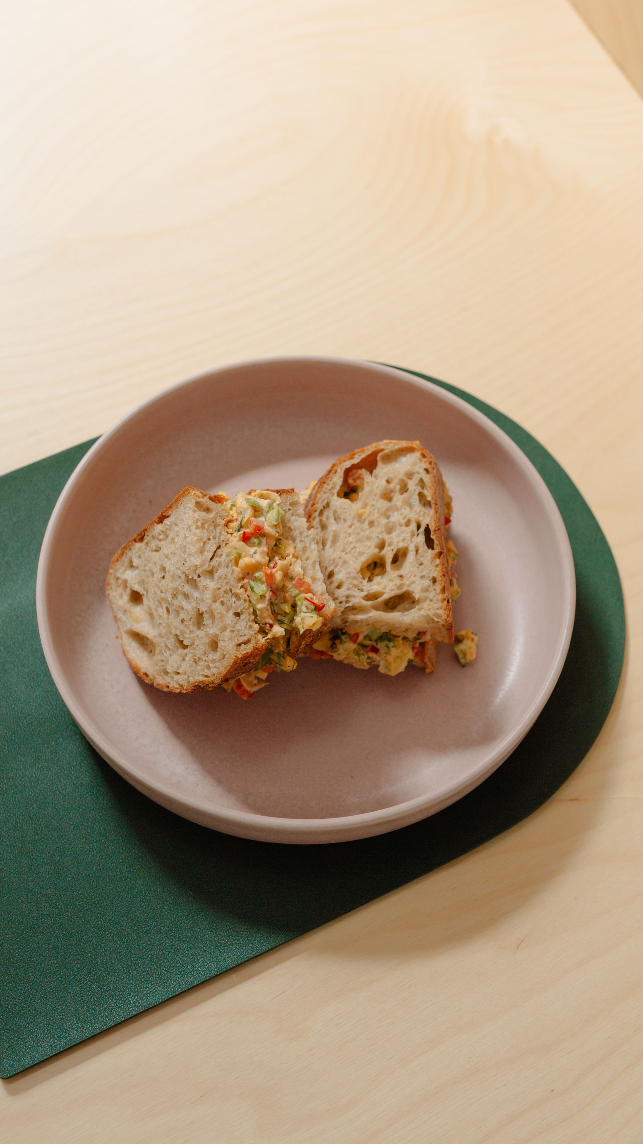 chickpea and kimchi sandwich on a green placemat