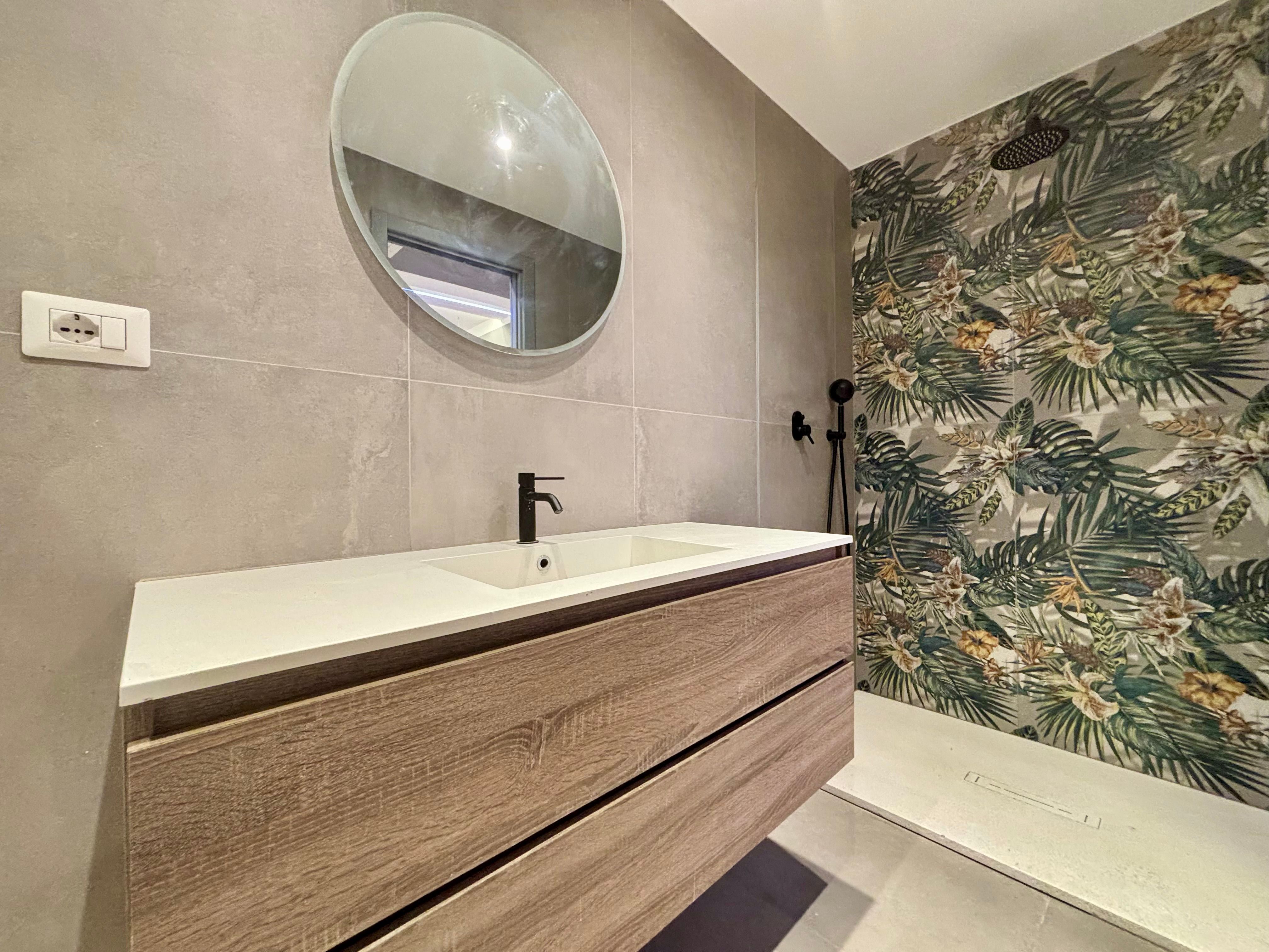 bathroom with sink mirror and shower