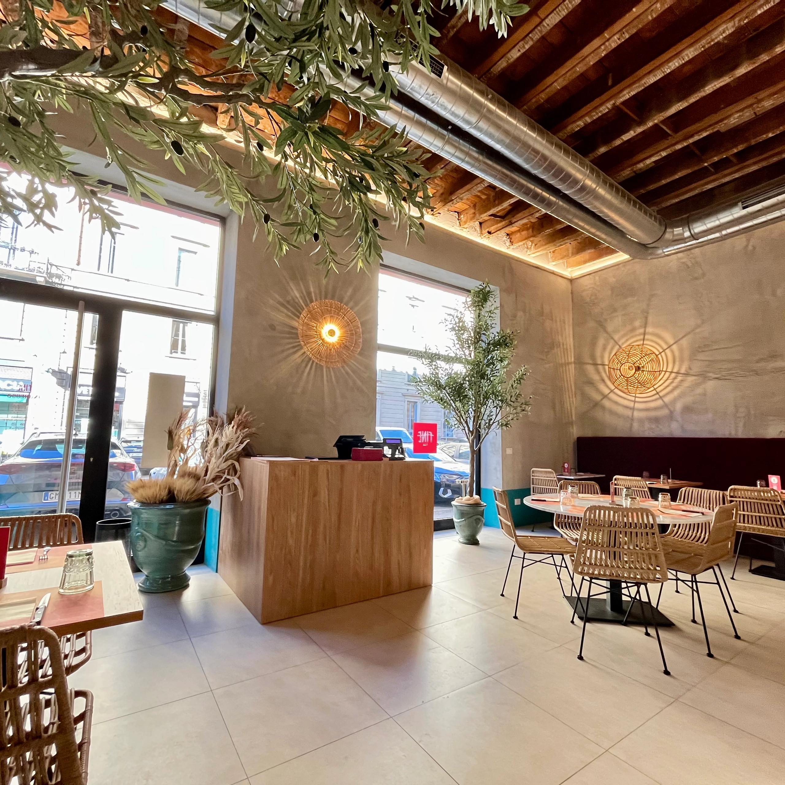 Two display windows, Entrance door, Tables and chairs, Cash counter, Wooden ceiling, Decorative plants