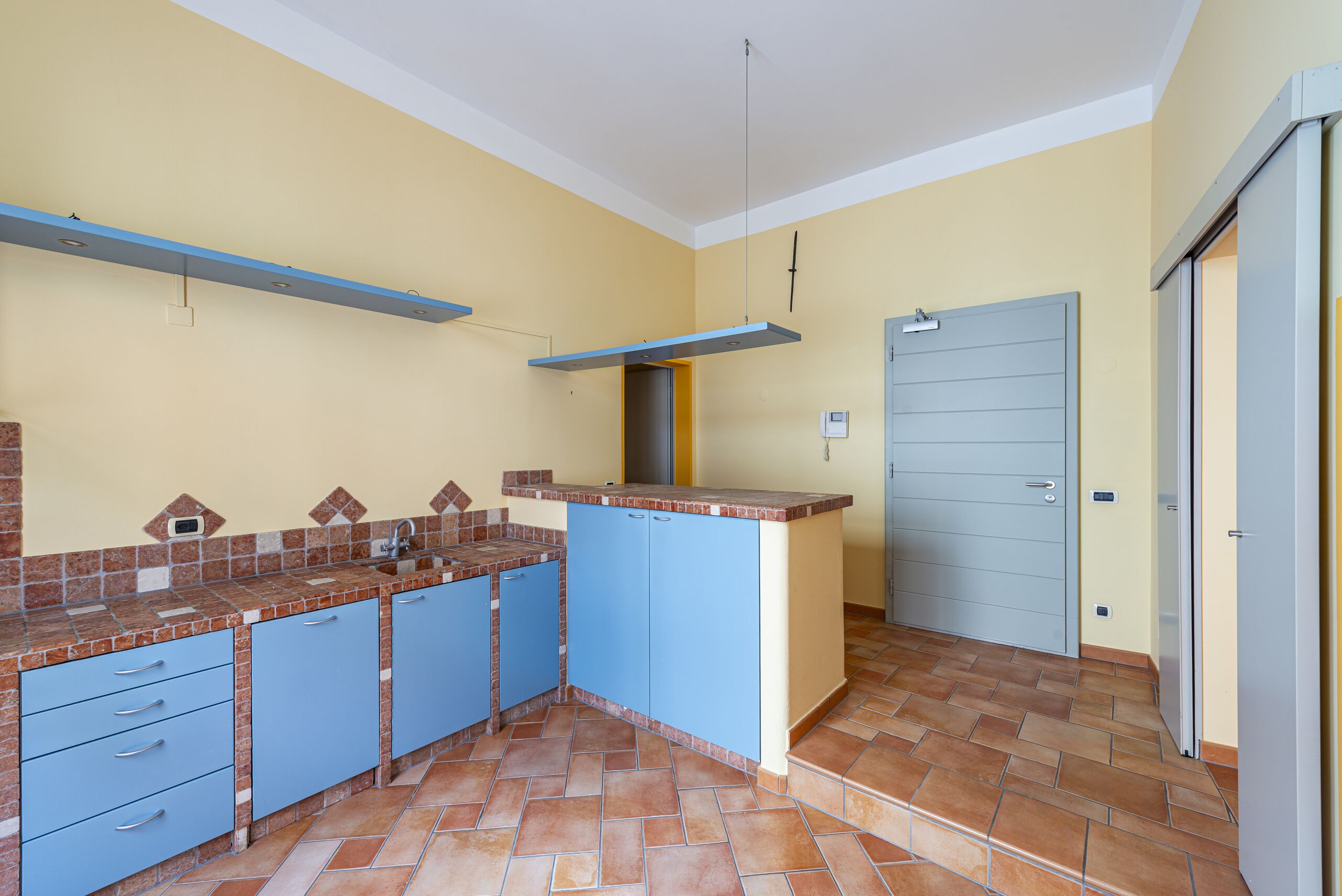 Kitchen with shelves, Doors, Terracotta tile floor