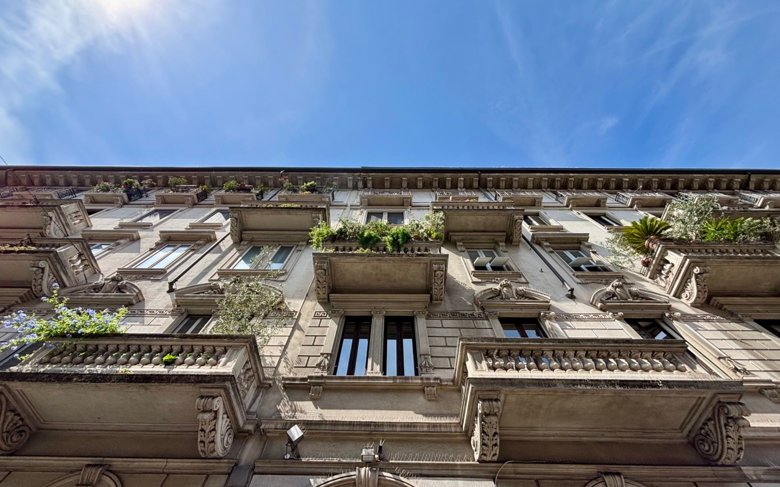 Building with windows balconies and plants