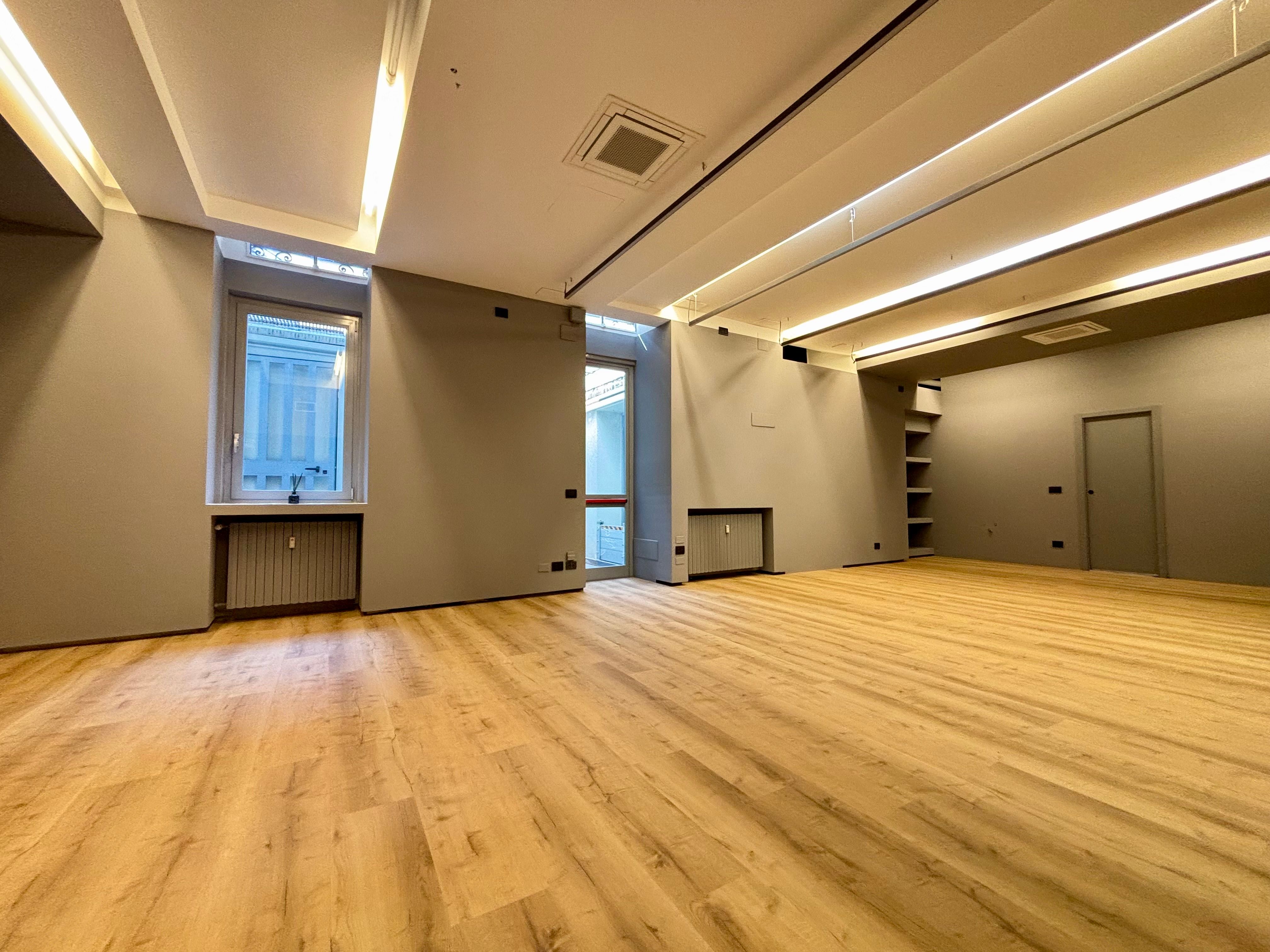 windowed open space office with wooden floor