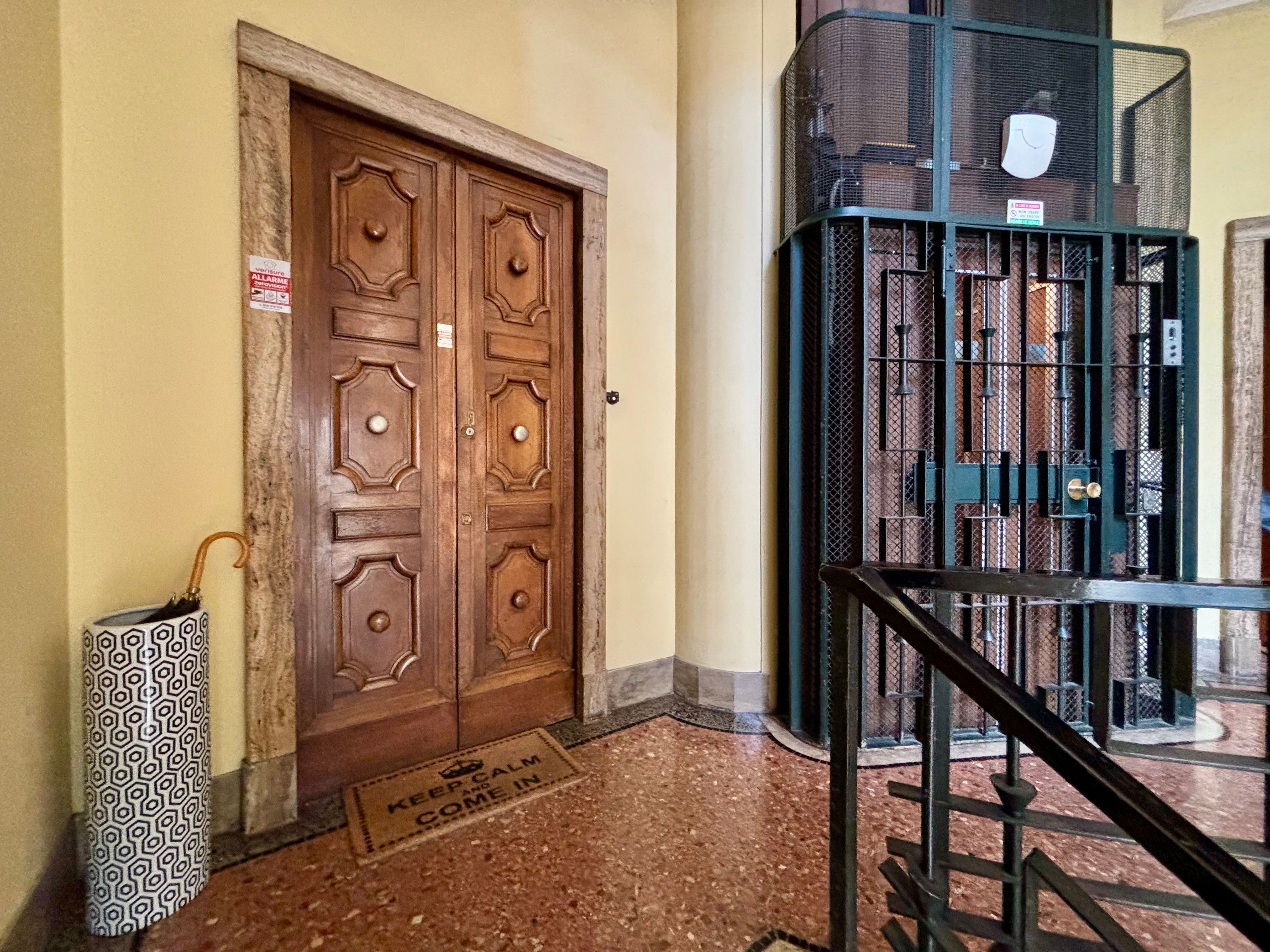 entrance door, elevator, umbrella stand