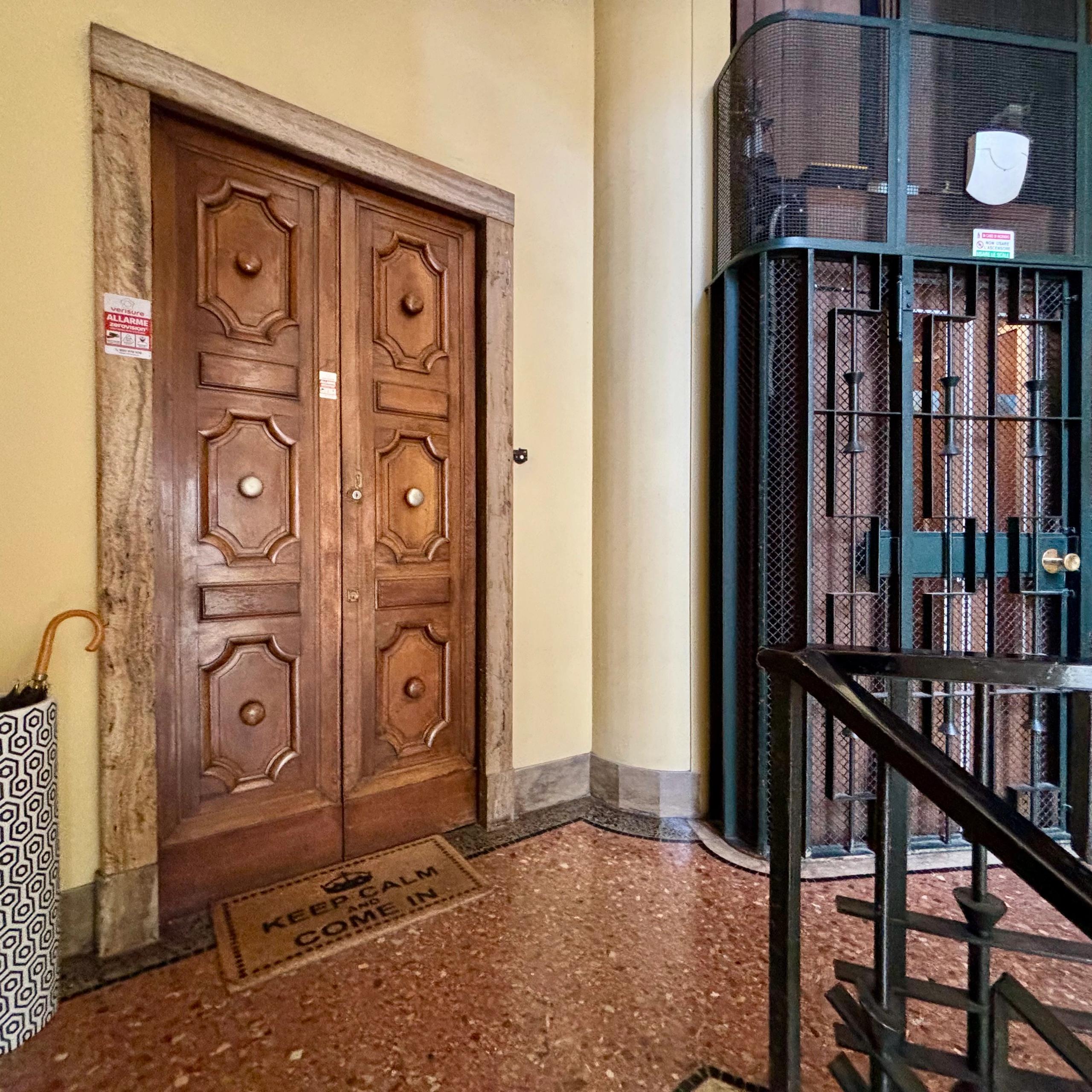 entrance door, elevator, umbrella stand