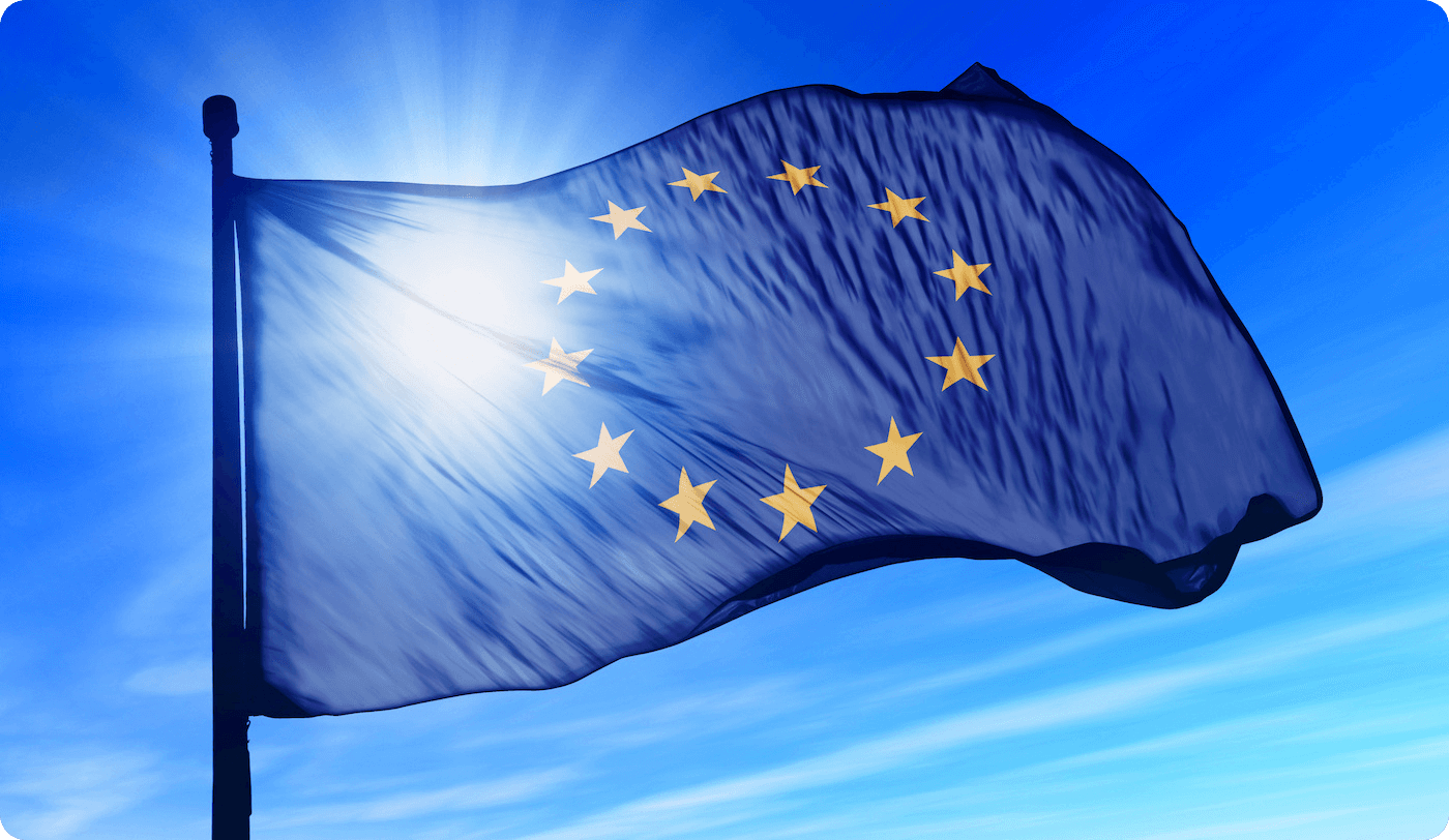 The EU flag waving in the sky with sunlight passing through